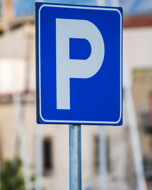 blue parking lot sign in the city